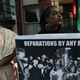 Activists stage a protest July 1, 2019, to mark National Reparations Day outside the Washington, D.C., residence of Senate Majority Leader Mitch McConnell (R-Ky.) to address remarks McConnell made this summer opposing reparations that protesters considered “offensive and dismissive.”